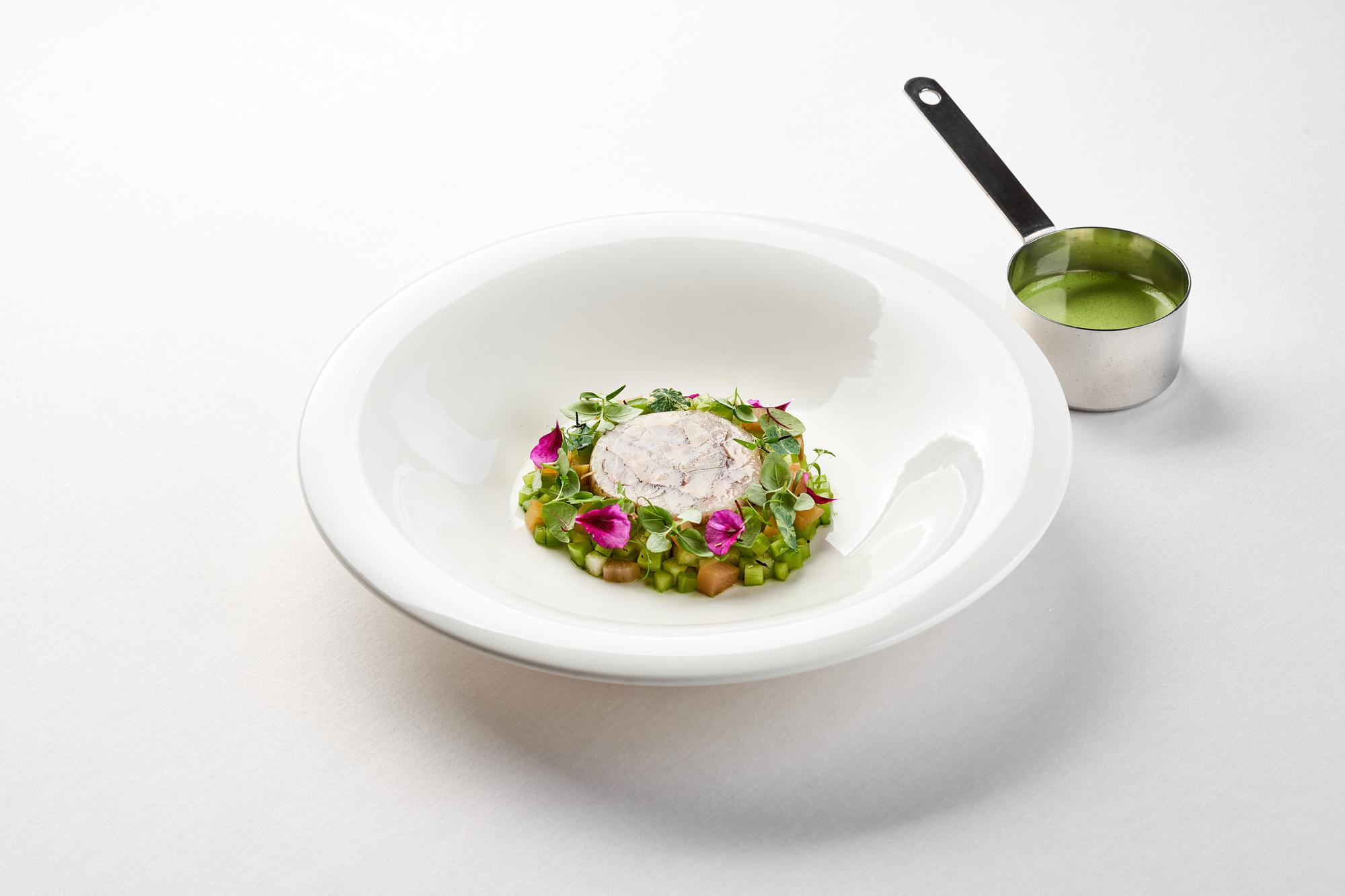 detail of plated dish with local herbs in a circle mask